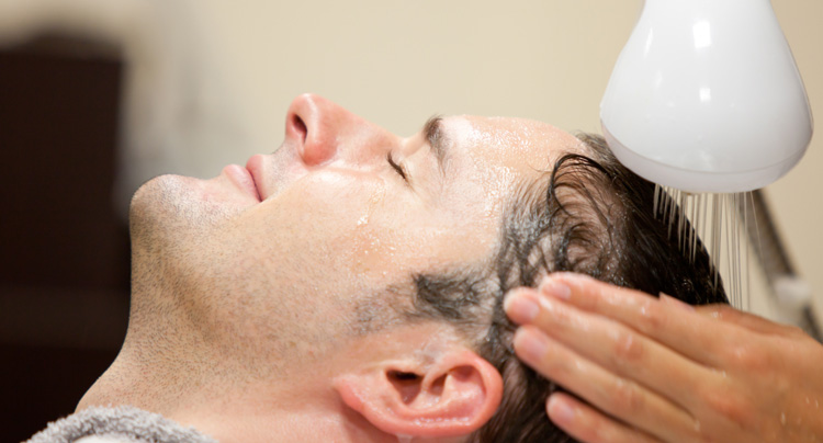 getting hair washed at a barber shop